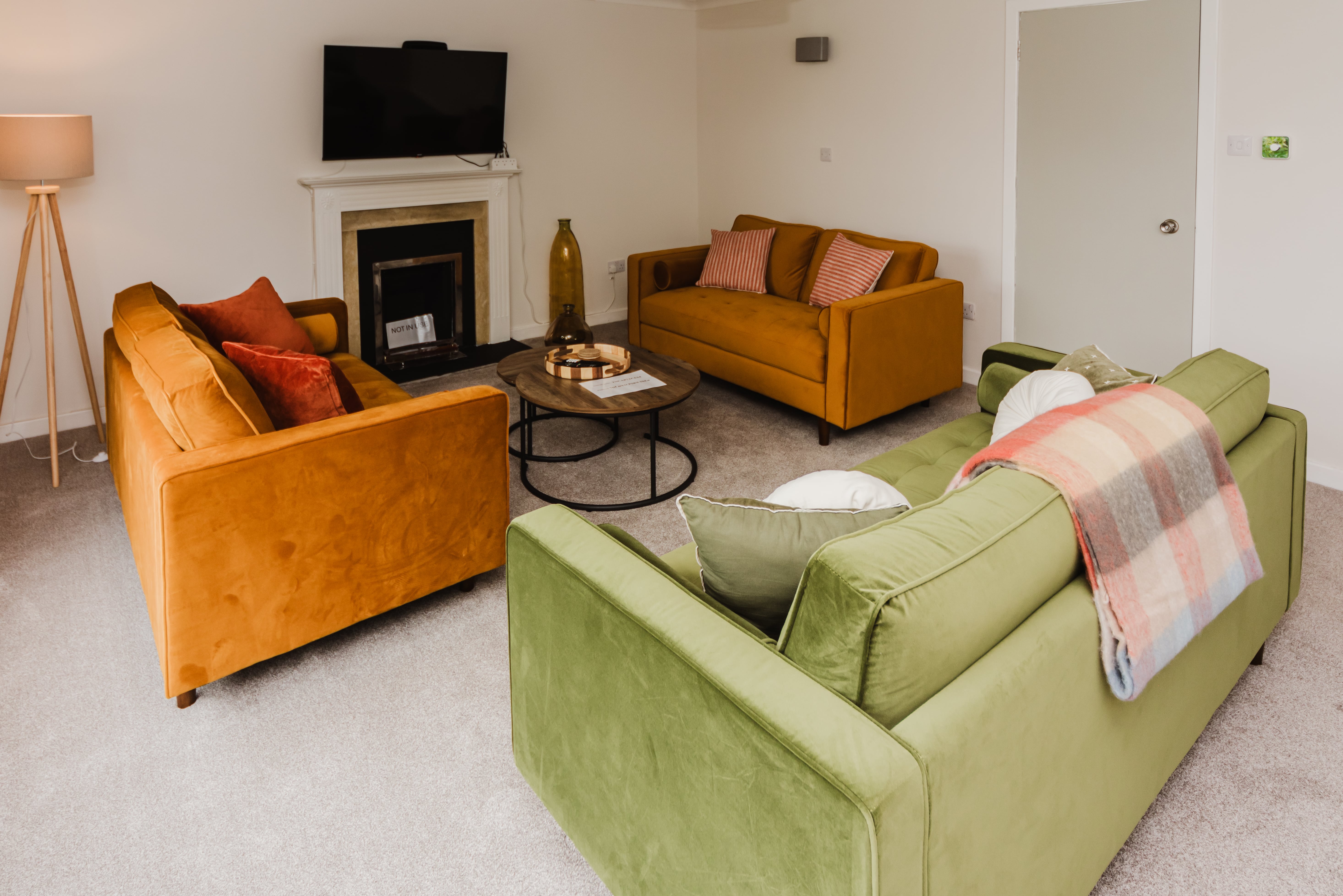 Spacious living area with sofas and smart TV